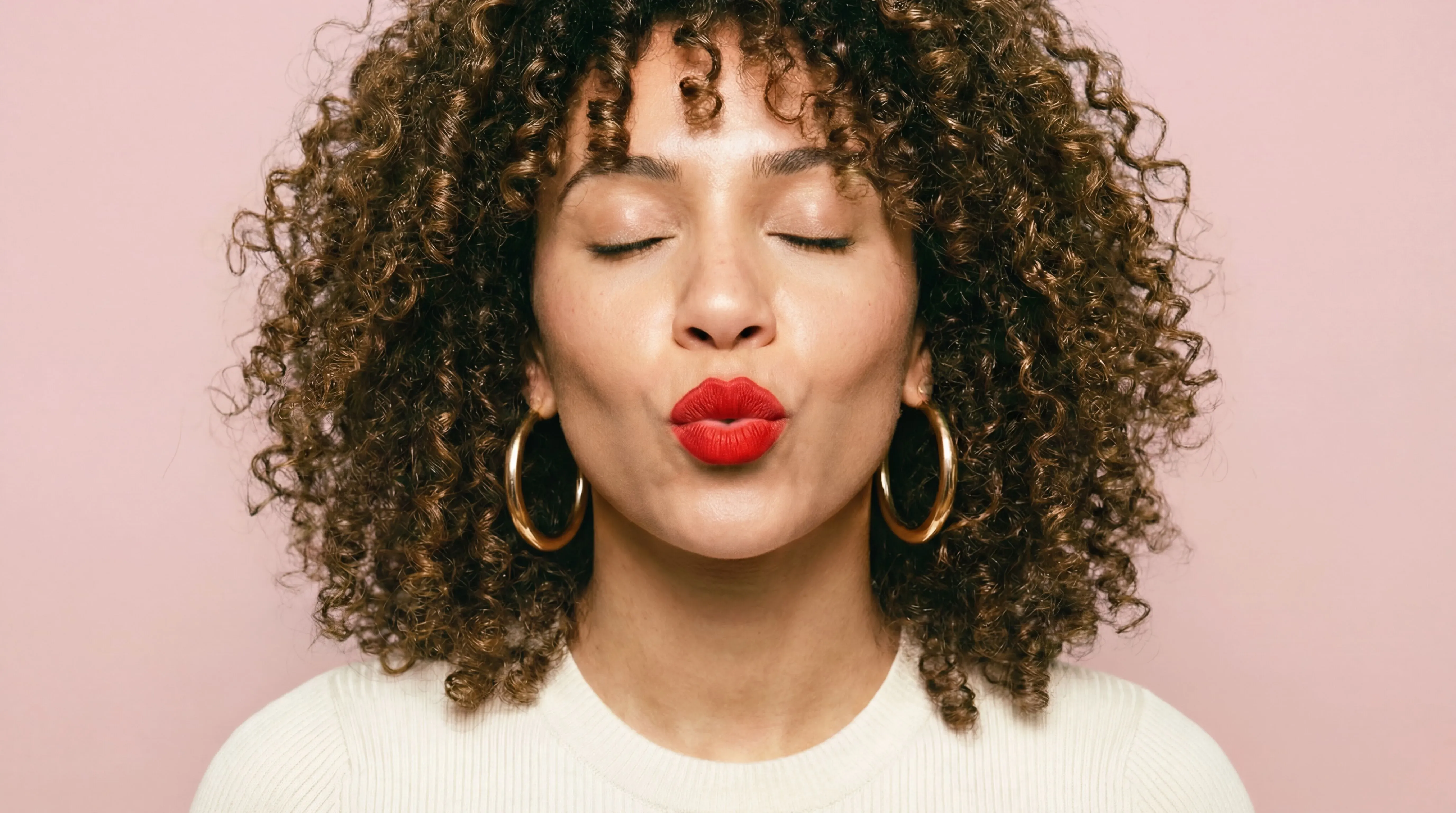 Woman with beautiful curly hair outdoors